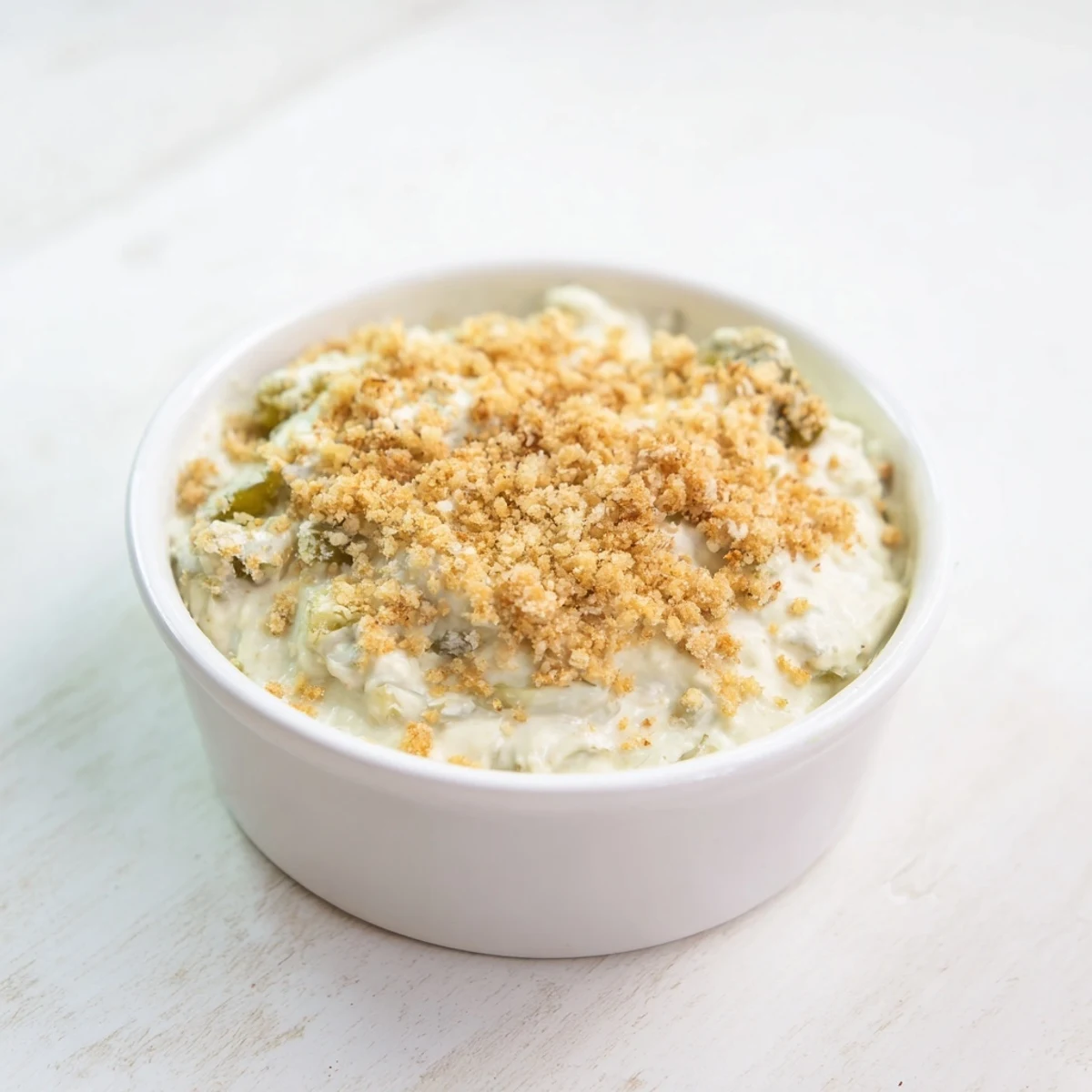 A vibrant image of creamy Fried Pickle Dip, ready to be scooped up with crunchy chips.