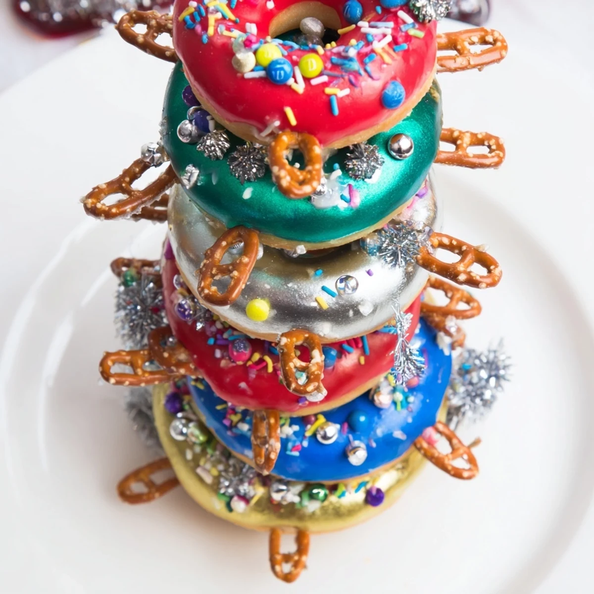 A glorious close-up of the donut stack Christmas ornament tower, showcasing a brilliant, edible centerpiece.