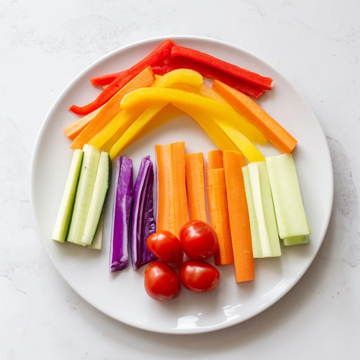 Vibrant Rainbow Arch Bright Veggie Sticks, a visually stunning arrangement of colorful vegetables served with a dip.