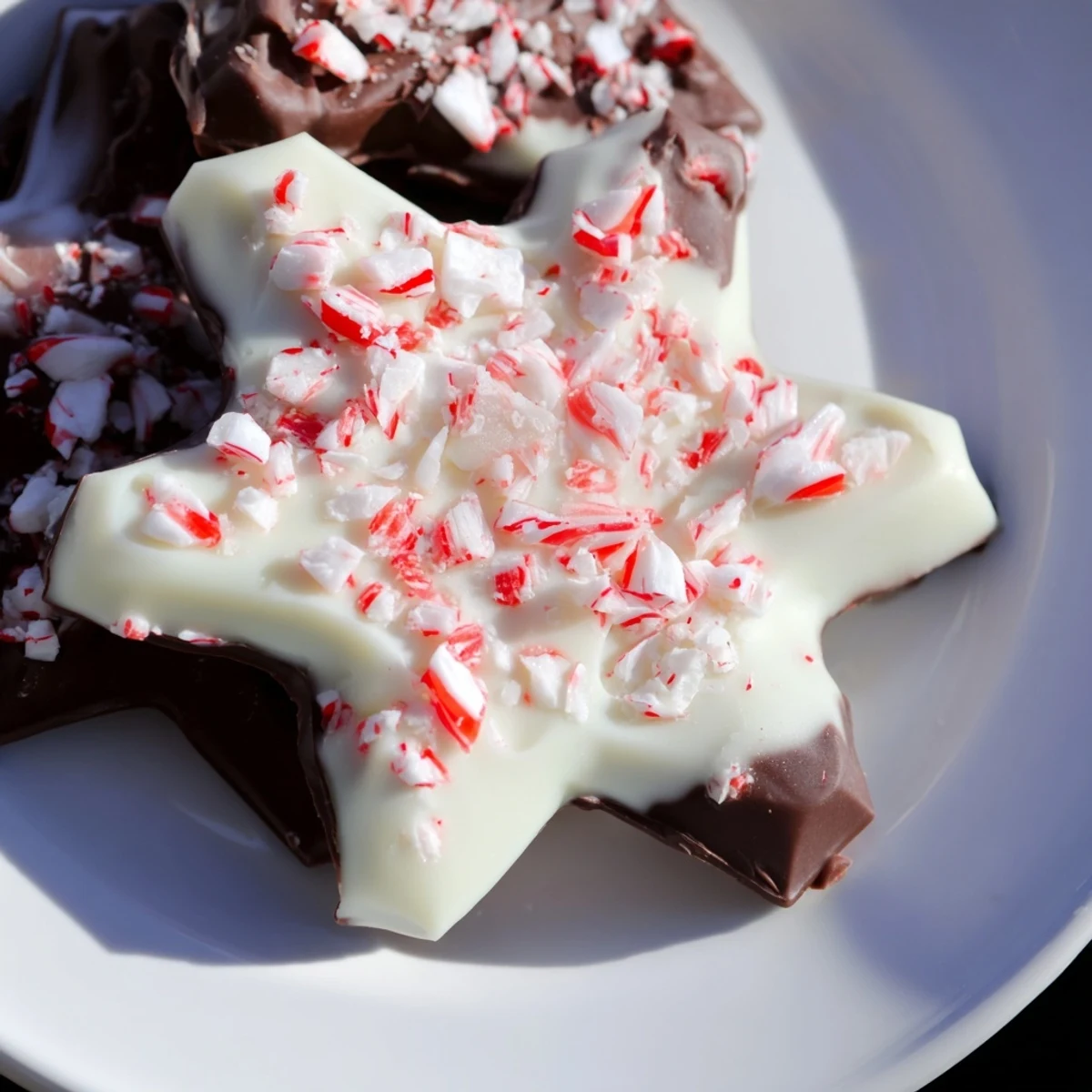 Close-up of freshly made Peppermint Bark Snowflakes with a crisp, crackling surface and bright mint.