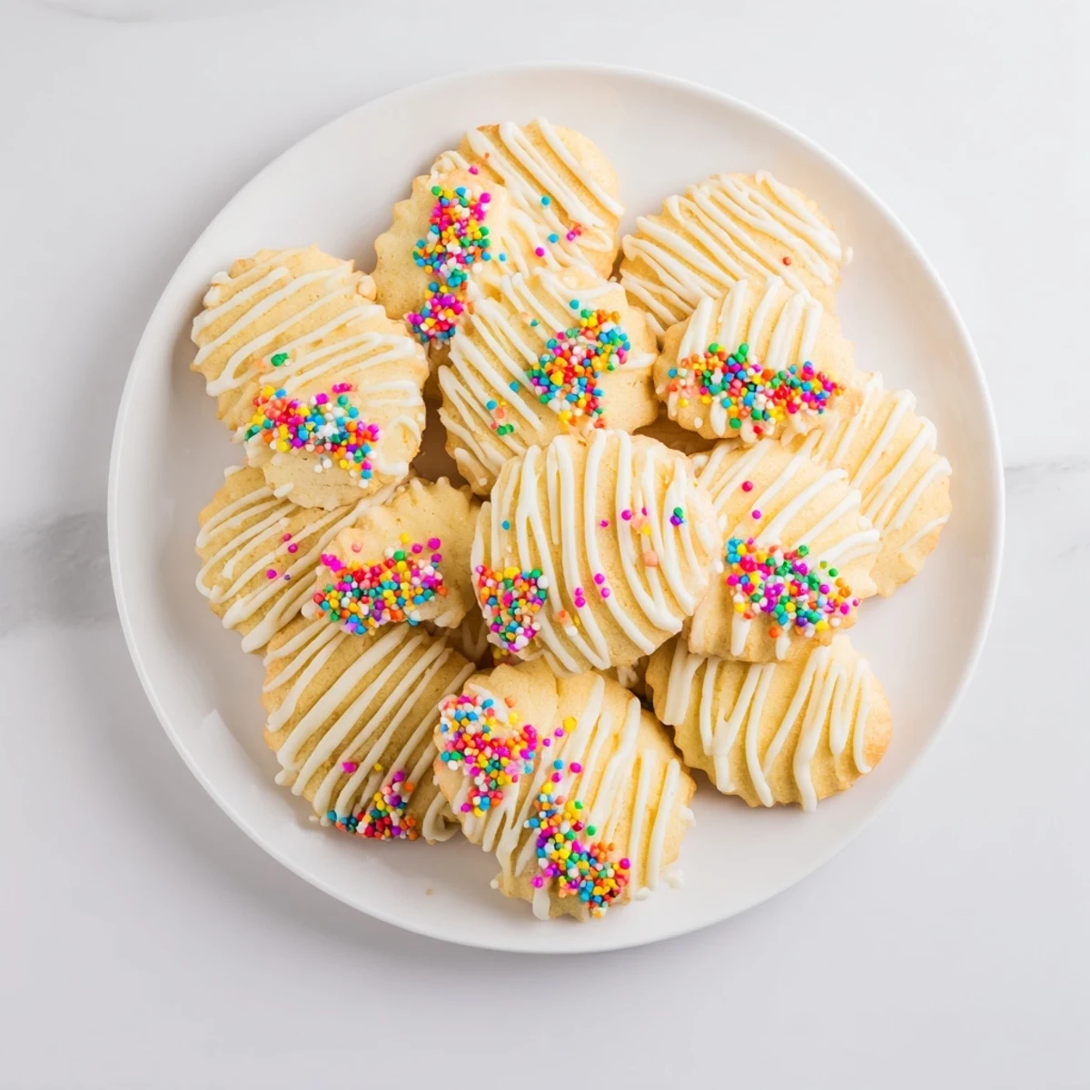Golden-edged spritz cookies, beautifully layered in a fan shape, perfect for any holiday celebration.