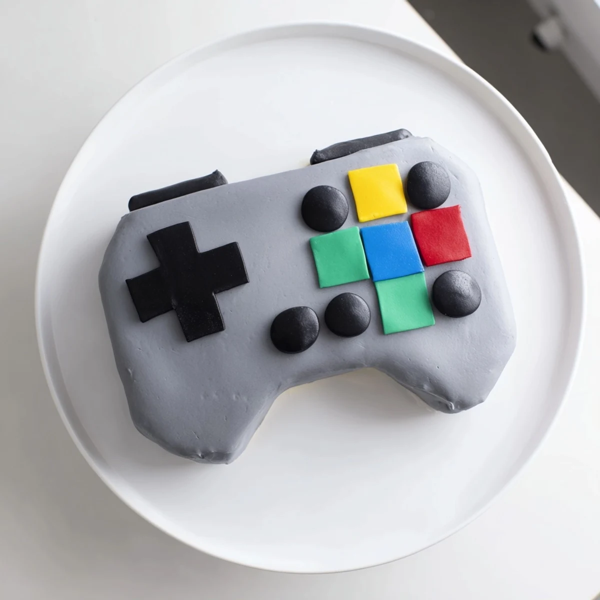 A colorful Pixel Video Game Controller Cake, displaying vibrant fondant details, perfect for a gamer's birthday.