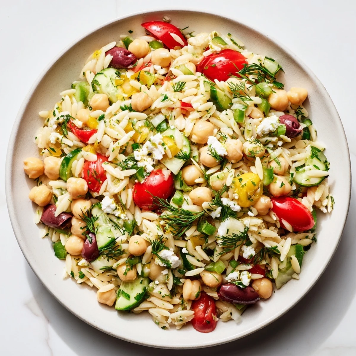 Tangy lemon vinaigrette perfectly coats each ingredient in this delicious Greek Lemon-Orzo Bean Salad.