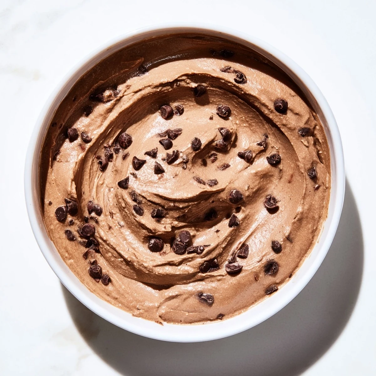 This decadent chocolate hummus features a beautiful dark color, served with a selection of tasty dippers.