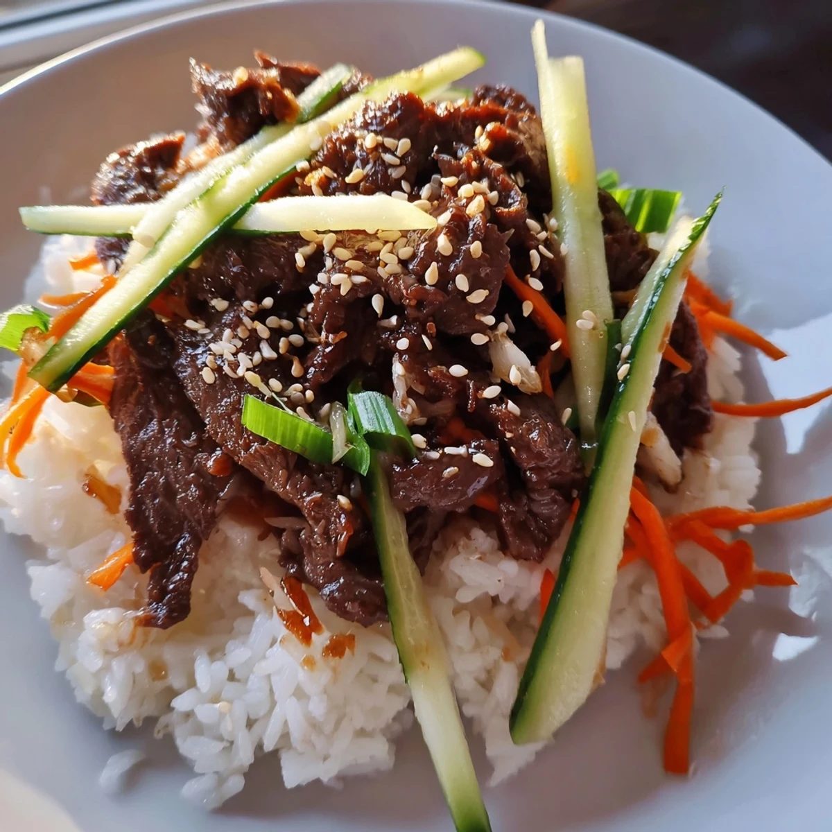 Bulgogi beef bowl with glistening marinated beef, vibrant vegetables, and fluffy jasmine rice.