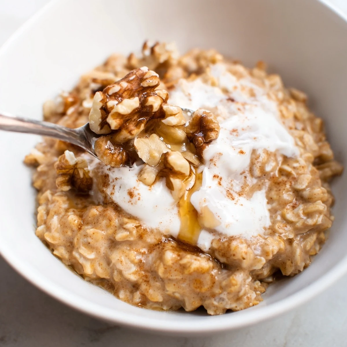 Steaming Pumpkin Spice Latte Oats, topped with whipped cream and a sprinkle of cinnamon.
