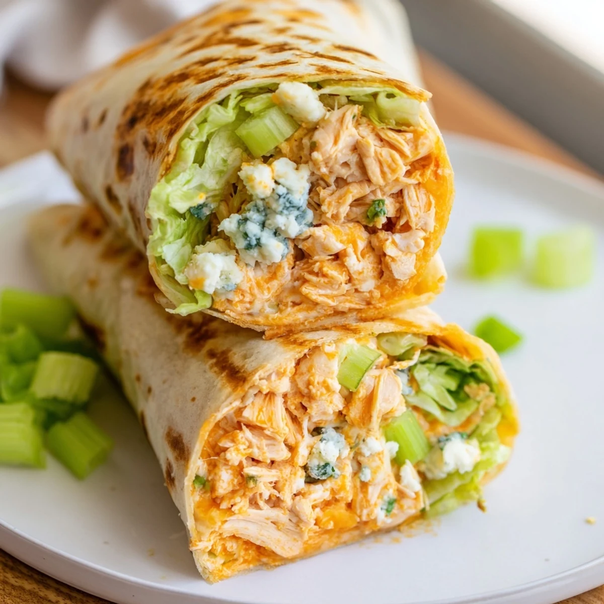 Golden-brown Buffalo Chicken Dip Wrap, with melty cheese and crunchy celery, ready to serve.