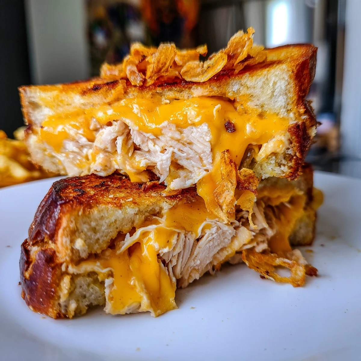 Golden-brown Crispy Shallot Chicken Grilled Cheese with melted cheese oozing out, a decadent treat.