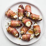 Golden-brown goat cheese stuffed bacon wrapped dates, perfect for a Mediterranean-inspired party appetizer.