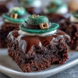 Adorable Leprechaun Hat Brownie Bites with chocolate-dipped marshmallows and green icing for St. Patricks Day.  