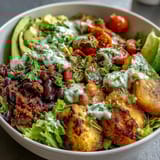 Vibrant taco salad bowls packed with lean turkey, crisp lettuce, black beans, and avocado, drizzled with homemade Greek yogurt ranch.  