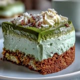 Delicate ladyfingers dipped in matcha blend, stacked with airy mascarpone cream, creating a beautiful green-hued Italian-Japanese fusion dessert.
