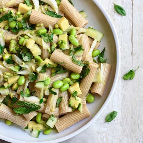 Vibrant Holiday Glow Green Goddess Protein Pasta Salad, featuring creamy dressing and colorful vegetables, waiting to be enjoyed.