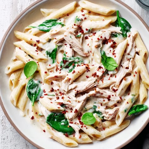 A bowl of savory, creamy One-Pot Creamy Spinach & Turkey Christmas Pasta, perfect for a warming meal.