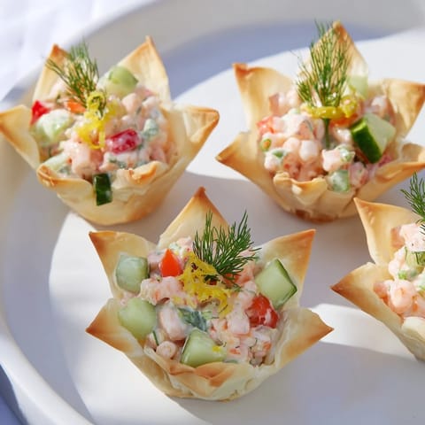 Crisp phyllo pastry cups hold a creamy shrimp salad in these tempting Mini Star Cocktail Cups.