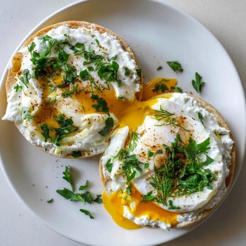 Turkish-American Çılbır Eggs Benedict: Vibrant fresh herbs garnish the decadent, flavorful breakfast dish.