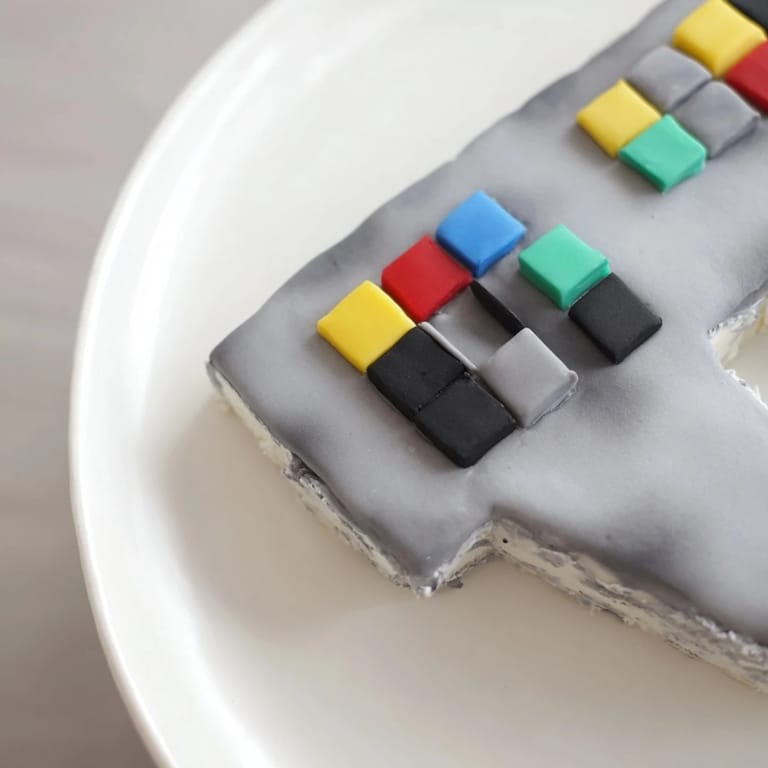 Imagine this delightful Pixel Video Game Controller Cake, layered with vanilla, frosted and beautifully presented on a platter.